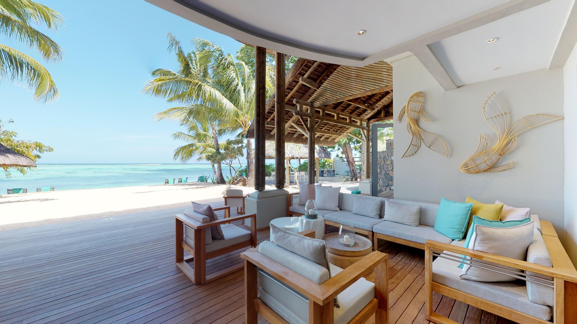 Beachfront terrace of the Presidential Villa at Paradis Beachcomber, overlooking a turquoise lagoon
